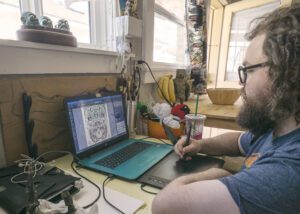 Man working on laptop, digital drawing