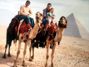 Family riding two camels in Egypt