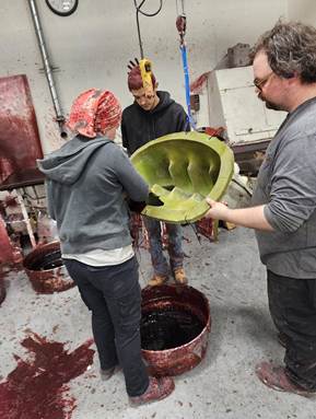 Artisans creating a wax pattern for the foot. 