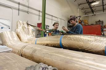 Artisans assembling the leg components of the playground.
