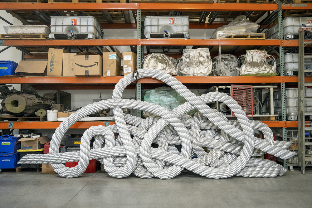 Parts of the rope form are cast in aluminum, leaning against shelving in the metal shop.
