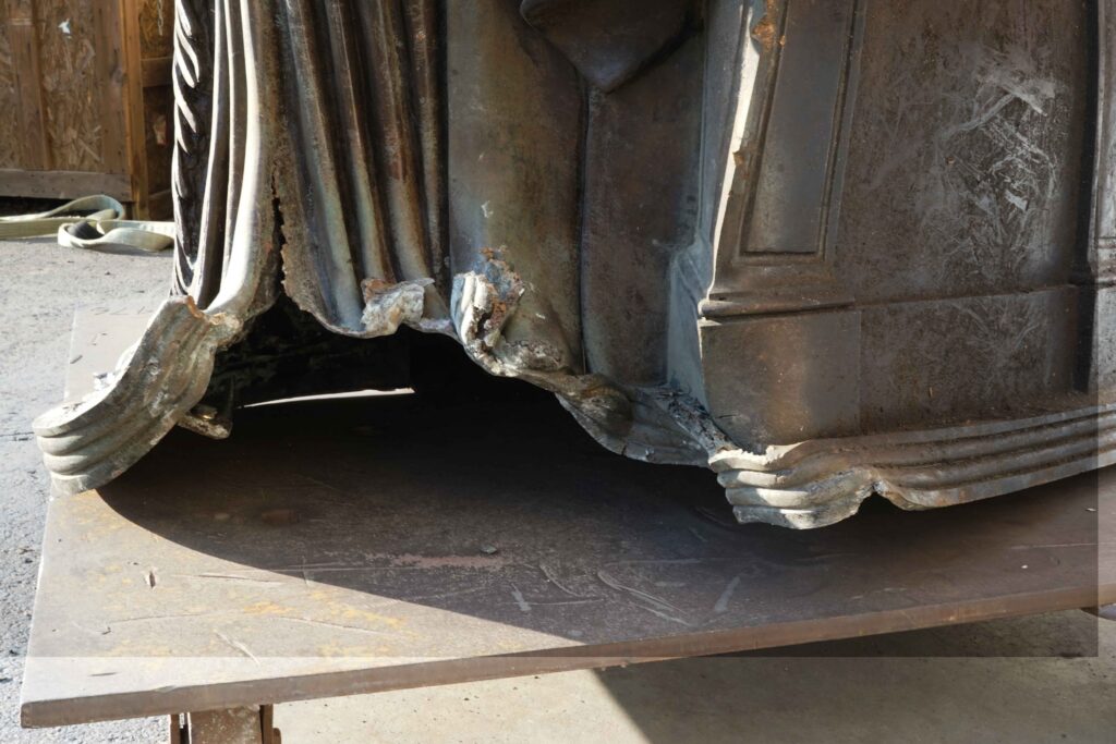 Close up of damage to the bottom of the sculpture. 
